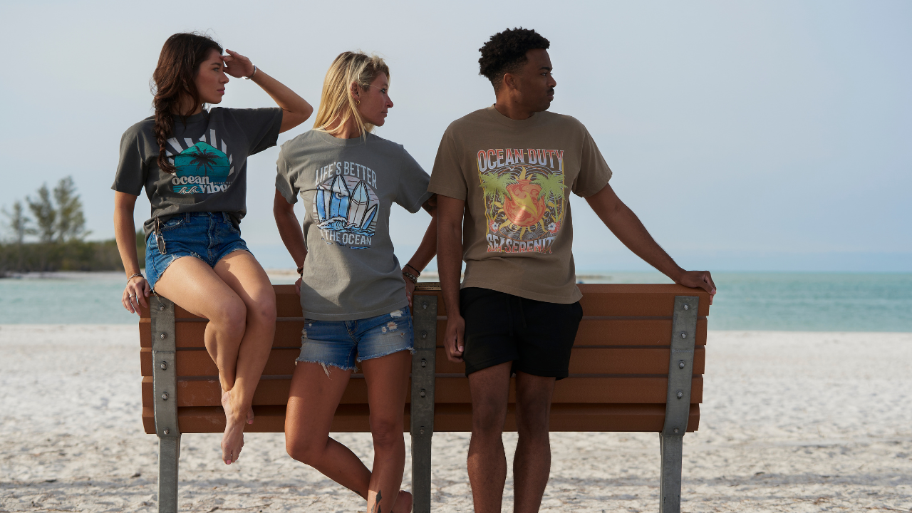 The people standing on posing with with T-shirts from Ocean Duty. A brand dedicated to ocean conservation.