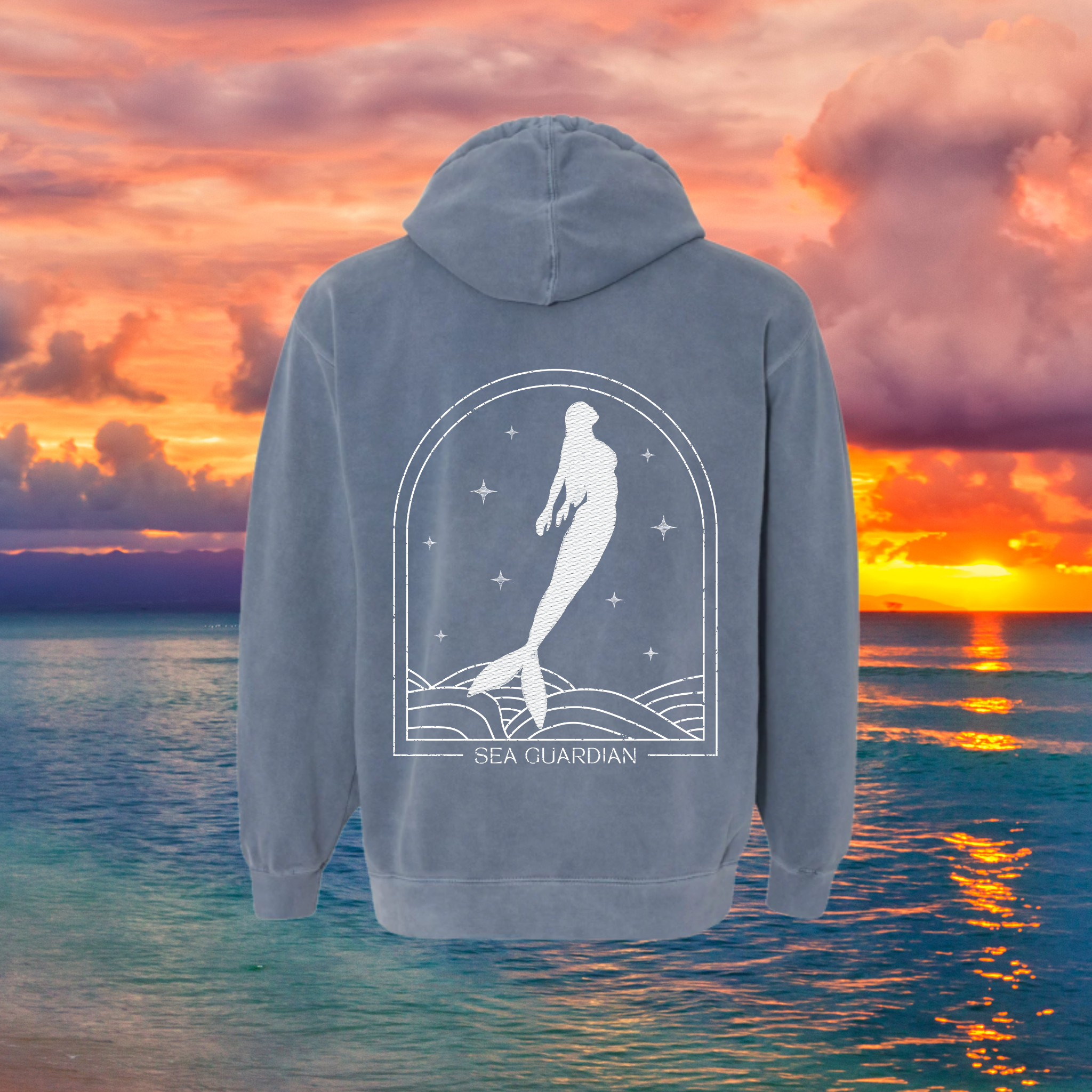 Hoodie with mermaid design on a background of a sunset over water