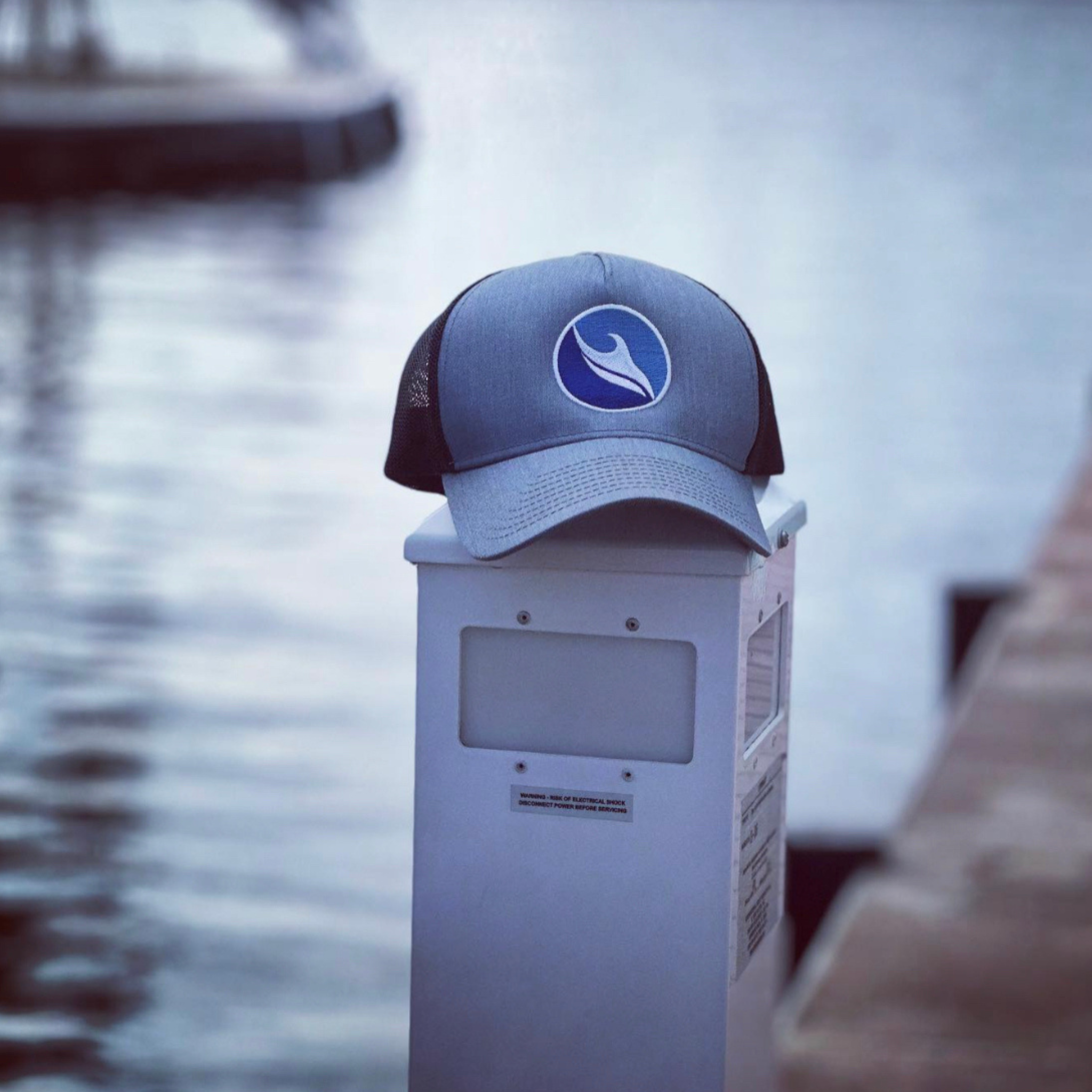 Ocean Duty Logo Embroidered Trucker Hat over water