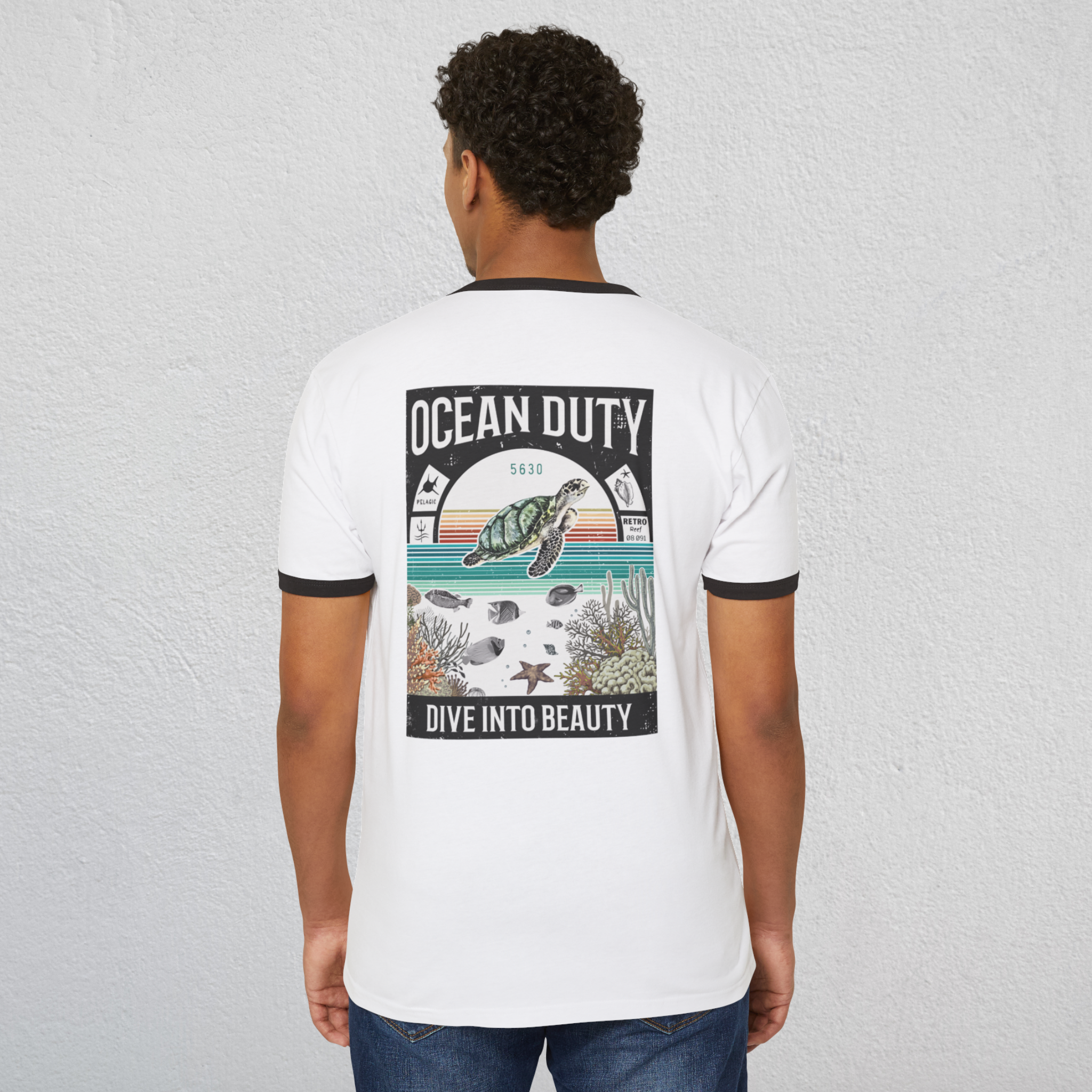 A man wearing a ringer t-shirt with a vintage distressed ocean poster on the back