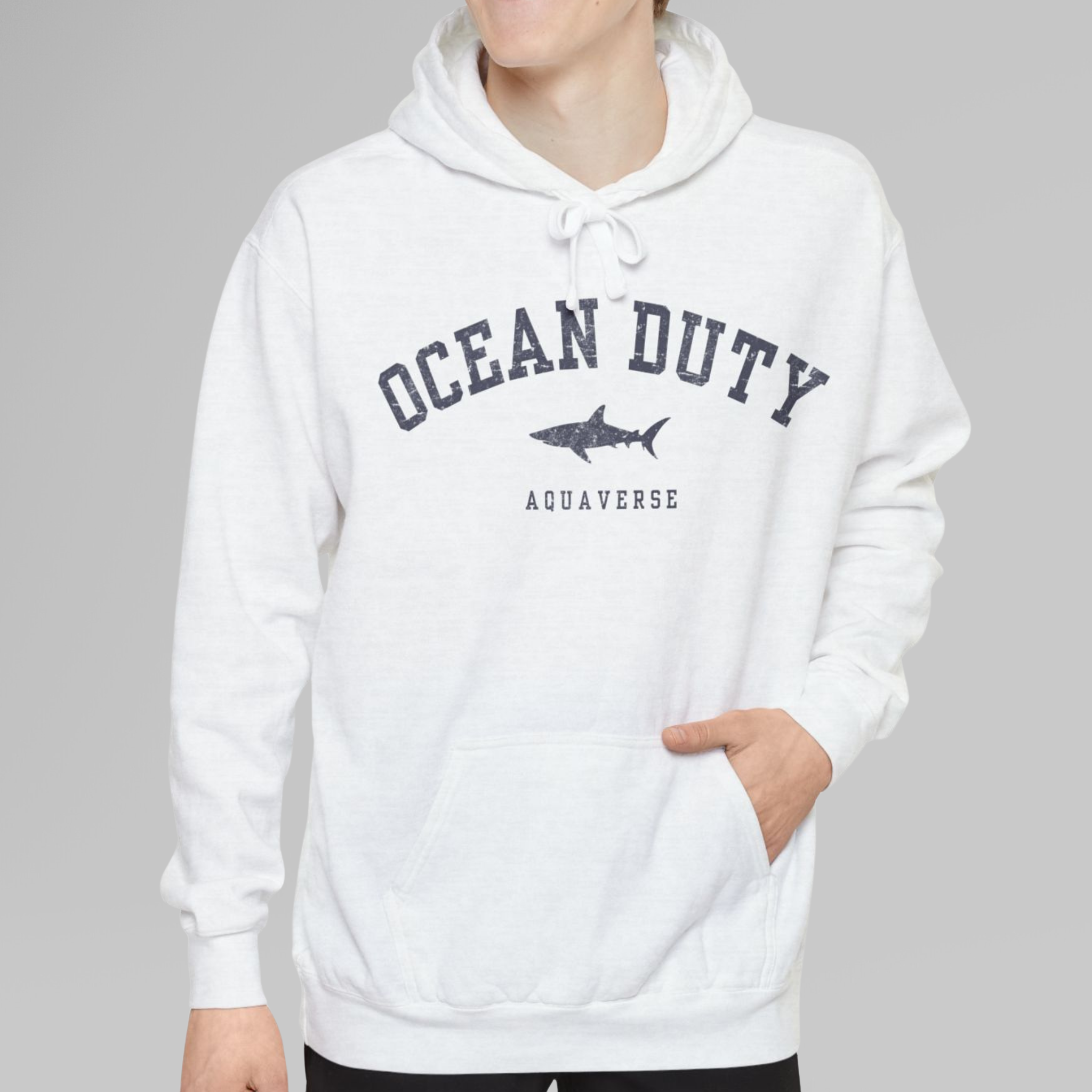 White hoodie with 'Ocean Duty' and shark graphic on a gray background