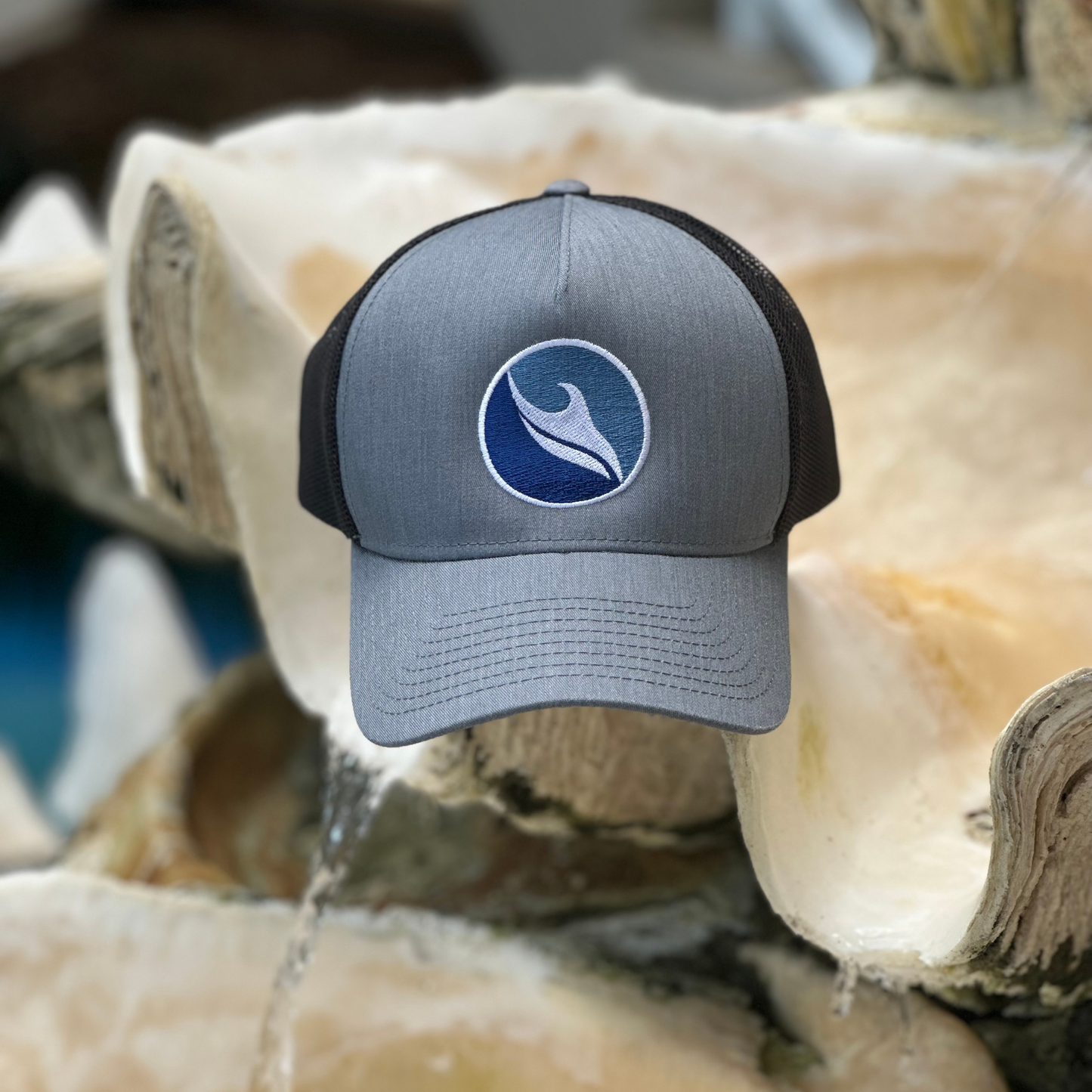 Ocean Duty Logo Embroidered Trucker Hat on seashell
