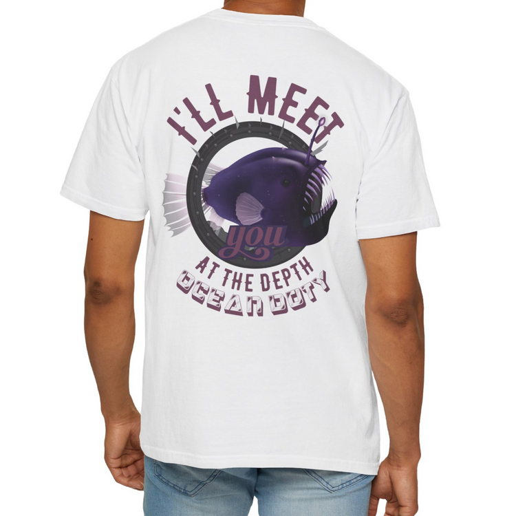 A person wearing a white t-shirt with a vibrant purple deep sea fish referring to the ocean's depth.